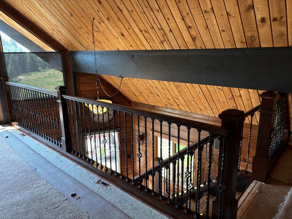 Custom wood and wrought iron staircase and loft railing remodeled in a Sandy, Oregon home